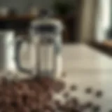 A close-up of a French press and freshly ground coffee beans