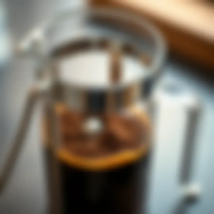 A detailed view of coffee grounds in the French press after brewing