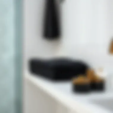 Neatly Arranged Black Towel Stylish black towel folded neatly on a bathroom shelf